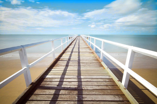 Pier to the ocean with nothing else in sight.