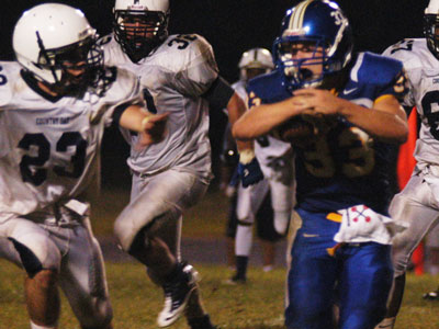 A man about to be tackled while playing football.