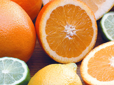 Oranges, lemons and limes cut in half on a table.
